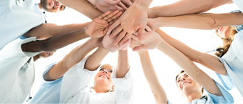 Home health team with hands in